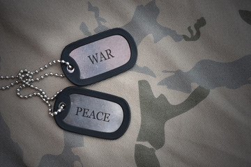 Wall Mural - army blank, dog tag with text war peace on the khaki texture background.
