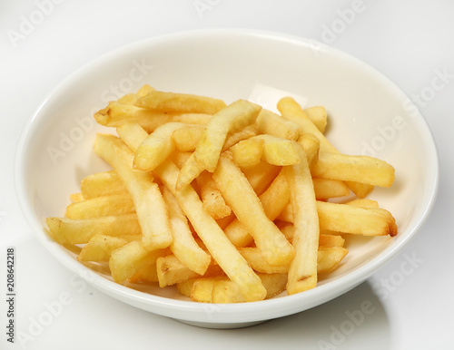Fotografía Garnish of french fries in a white plate on a white background