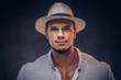 © Fxquadro - Close-up portrait of a handsome fashionable bearded man in a white shirt and panama hat.