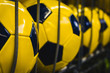 Rhythmic pattern background of new  yellow footballs. leisure time concept