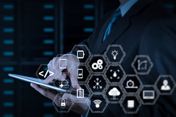businessman hand using tablet computer and server room