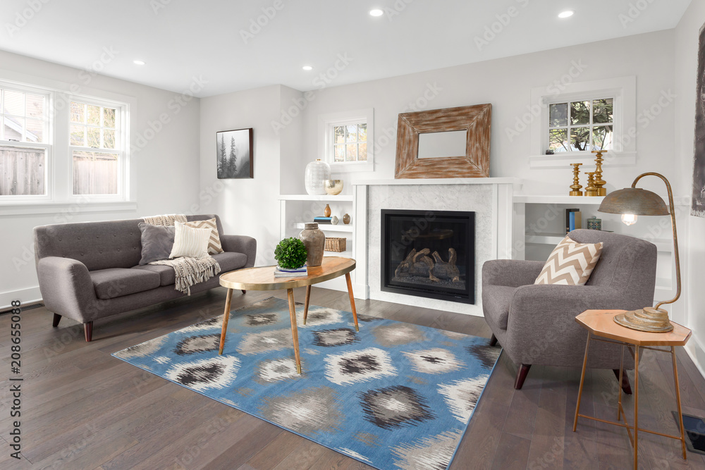 Beautiful living room interior with hardwood floors and fireplace in new luxury home - obrazy, fototapety, plakaty 