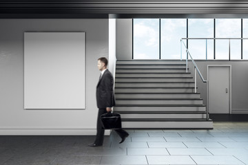 Wall Mural - Businessman walking in modern school corridor