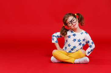 Wall Mural - funny child girl in glasses on colored background