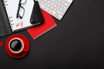 black background red coffee cup note pad alarm clock flower diary scores keyboard empty space desktop