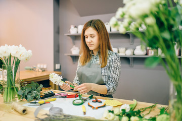 Wall Mural - Female florist prepares flower composition