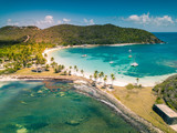 Aerial view of Mayreau beach in St-Vincent and the Grenadines - Tobago Cays. The paradise beach with palm trees and white sand beach