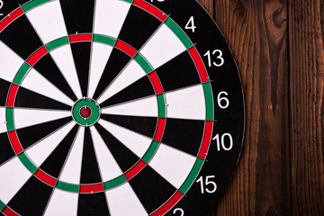 Wall Mural - Darts board. Target on wooden table background.