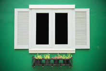 White Window Against A Green Wall