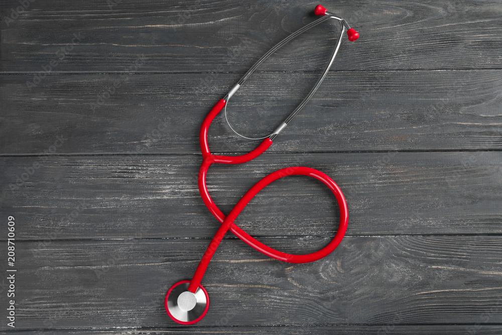 Stethoscope on dark wooden background