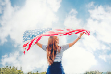 Happy woman standing with American flag Patriotic holiday.USA celebrate 4th of July