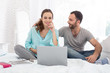 © Viacheslav Yakobchuk - Online access. Happy pregnant woman and man grinning and using laptop