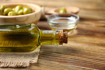 Bottle with olive oil on wooden table