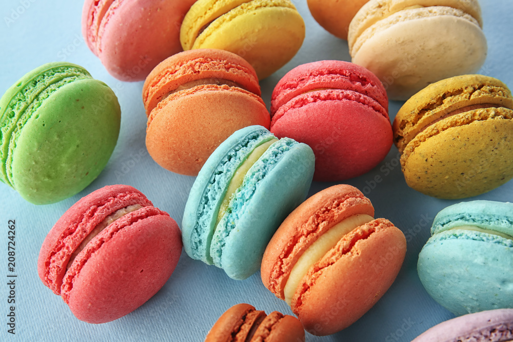 Delicious macarons on color background
