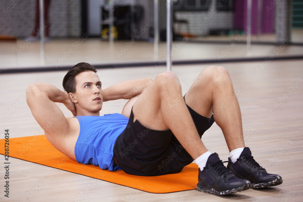 Young man training in modern gym
