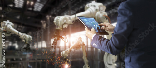 Cuadros en Lienzo Industrial engineer manager using tablet control automation robot arms machine in intelligent on monitoring