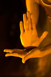 Dancer's hand gesture in orange light