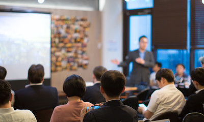 Fototapete - Presenter with Hands Pointing. Blurred De-focused. Unidentifiable Business Audience People Meeting in Conference Room. Speaker in Lecture. MBA Phd Teacher Giving Speech.