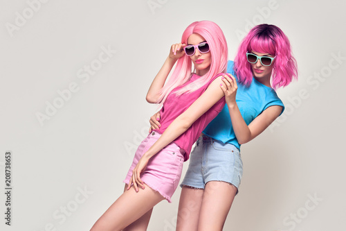 Two Girls Having Fun Dance. Pink Fashion Hairstyle Poster