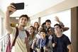 © PhotoAlto - Students posing for group selfie