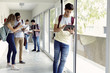 © PhotoAlto - Students hanging out in school corridor