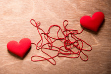 Two Red Heart And Complex Red String Connect Together On Wood Background, Love Concept