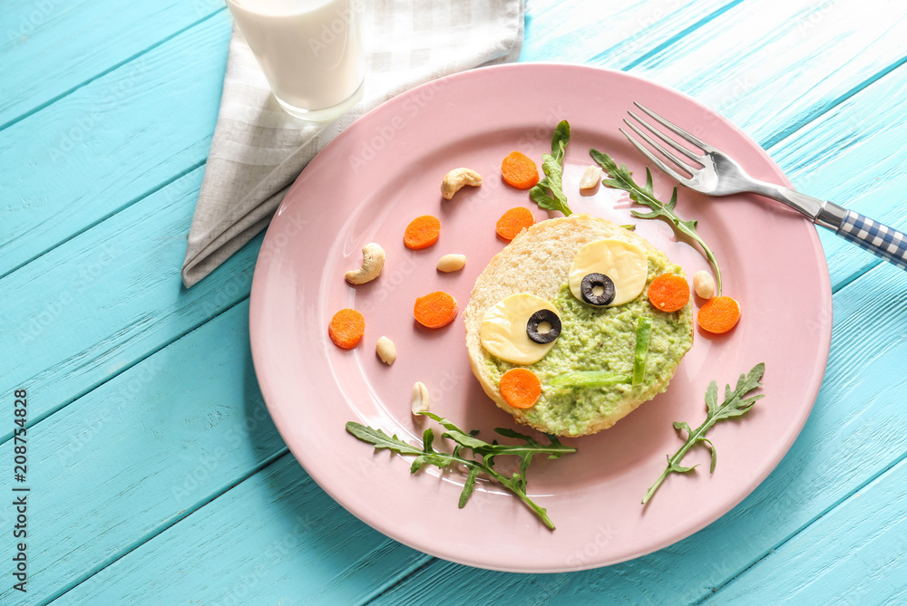 Plate with creative toast for children on wooden background