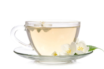 Glass cup of Tea with jasmine flowers and leaves isolated on white background