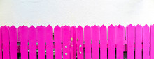 Bright Pink Wooden Fence In Front Of A White Wall