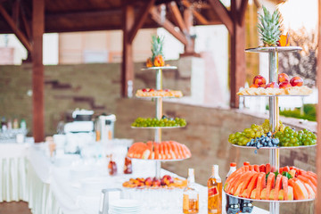 Wall Mural - Composition of catering stand with glasses, bottles and others prepared for outdoor party. There is a place for text.