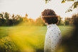 © Z A C - Rear view shot of handsome young male model with curly hair posing in the city park looking a side to the nature. Copy space for your advertising. People, lifestyle and emotion concept.