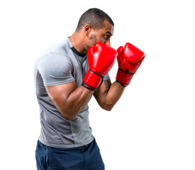 Strong sport man with boxing gloves in defense position on isolated white background