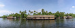 Panoramic river view and traditional house boat in Kerala's Backwaters, India.