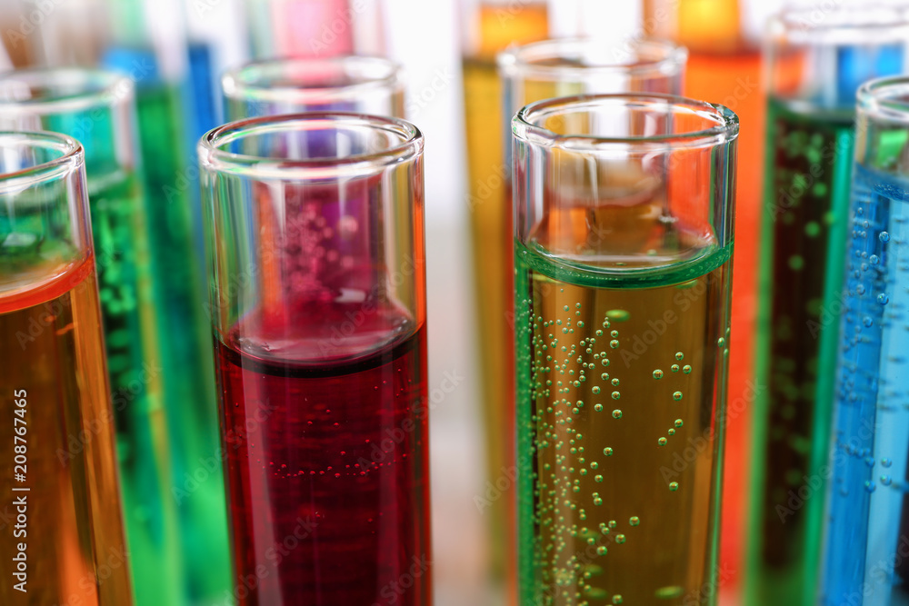 Many test tubes with colorful liquids, closeup