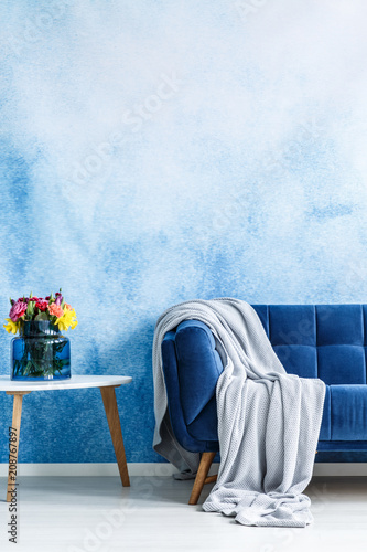 Comfortable Dark Blue Settee With Gray Blanket And Small