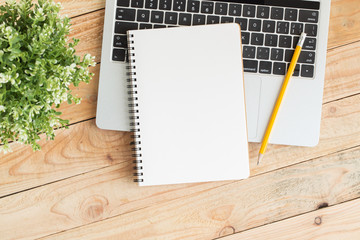Wall Mural - blank notebook with and pencil on laptop,flat lay photo of notebook for your message