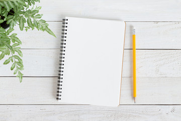 blank notebook with and pencil on white wood,flat lay photo of notebook for your message