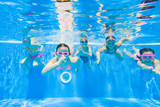 Fototapeta  - Children swim in  pool