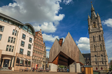 Sticker - Modern building and old clock tower with clouds and blue sky in Ghent. In addition to intense cultural life, the city is full of Gothic and Flemish style buildings. Northern Belgium.