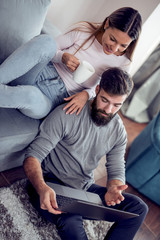 Wall Mural - Couple with laptop at home