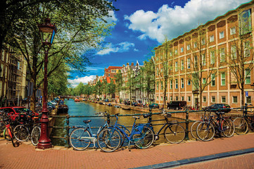 Sticker - Bridge on canal with iron balustrade, old buildings and bicycles in Amsterdam. Famous for its huge cultural activity and full of graceful canals. Northern Netherlands. Retouched photo.