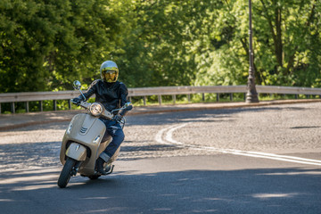 Man riding a classic scooter