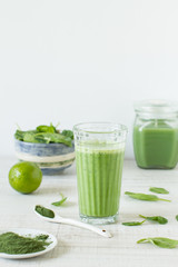 Detox, healthy green smoothie in a glass  with matcha and spinach