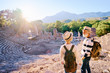 © luengo_ua - Travel and tourism. Senior family couple enjoying view together on ancient amphitheatre.