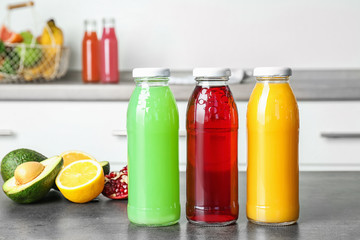 Poster - Bottles with tasty juices and ingredients on table