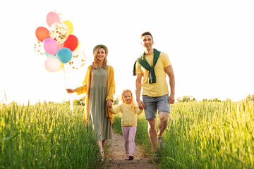 Wall Mural - Happy family with colorful balloons outdoors on sunny day