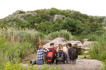 Sticker - Young people exploring map in wilderness. Camping season