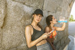 © victortorres/Stocksy - Fit women relaxing at wall