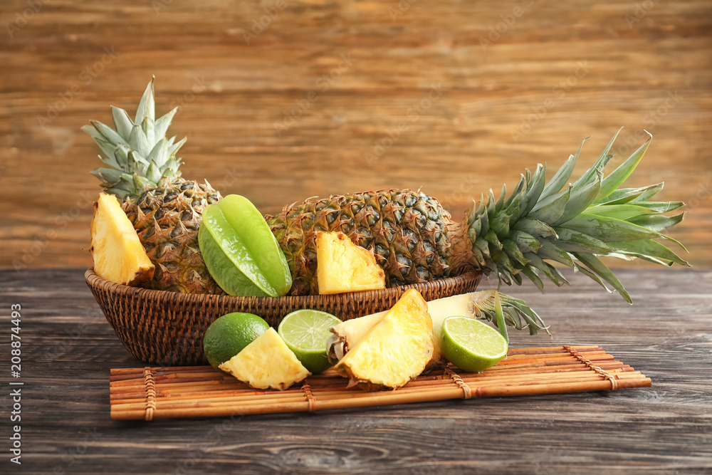 Composition with ripe fresh pineapple on wooden table