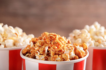 Cups with tasty popcorn, closeup